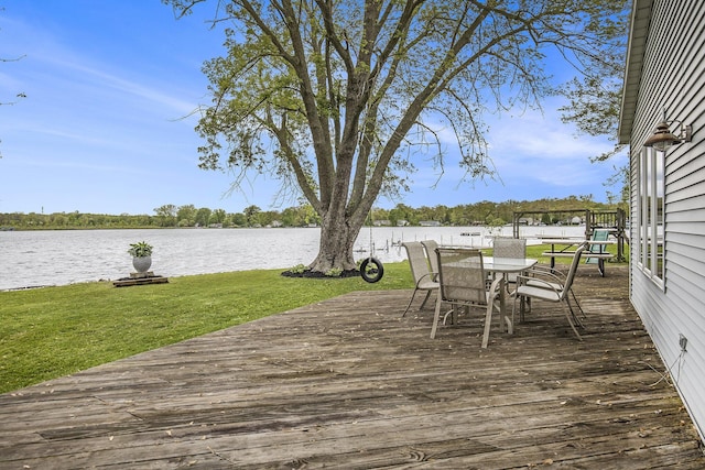 8928 Ellis St SE, Alto, MI 49302 - wooden deck featuring a water view, outdoor dining space, and a yard