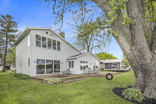 8928 Ellis St SE, Alto, MI 49302 - rear view of house with a chimney and a lawn