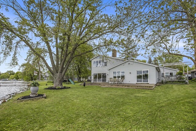 8928 Ellis St SE, Alto, MI 49302 - rear view of property featuring a playground, a chimney, a yard, and a wooden deck