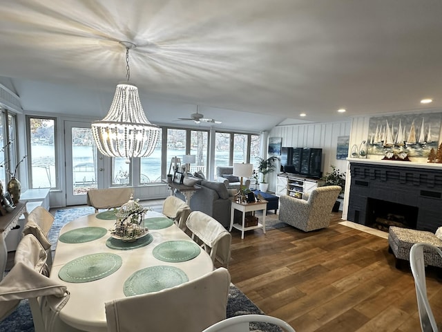 456 E Gull Lake Dr, Augusta, MI 49012 - dining space featuring dark wood finished floors, a brick fireplace, ceiling fan, a chandelier, and recessed lighting