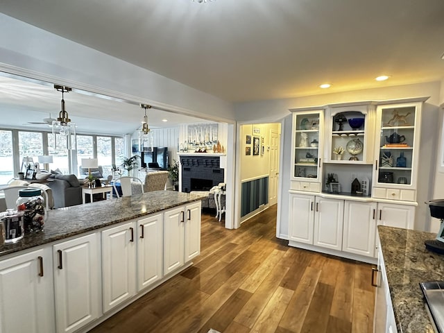 456 E Gull Lake Dr, Augusta, MI 49012 - kitchen featuring open floor plan, a brick fireplace, white cabinetry, and recessed lighting