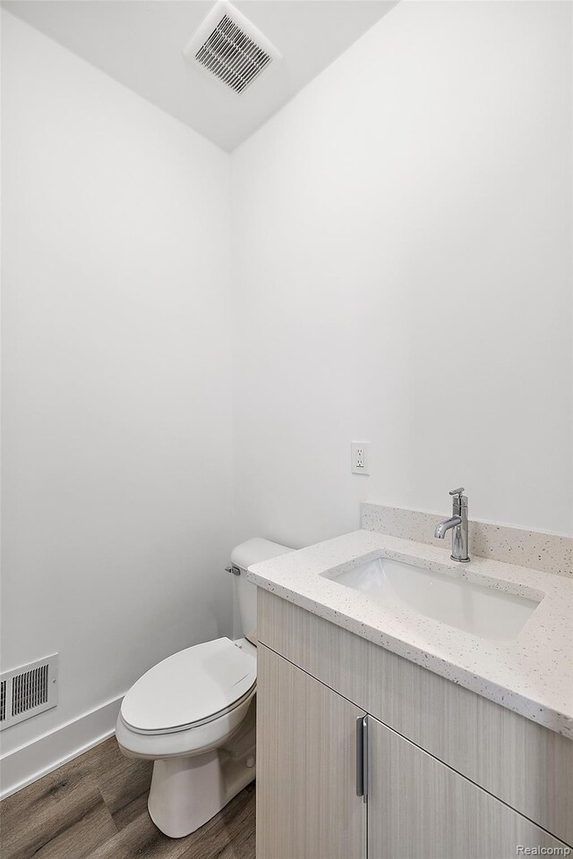 2817 Summers Pl, Troy, MI 48084 - half bathroom with vanity, wood finished floors, toilet, and baseboards