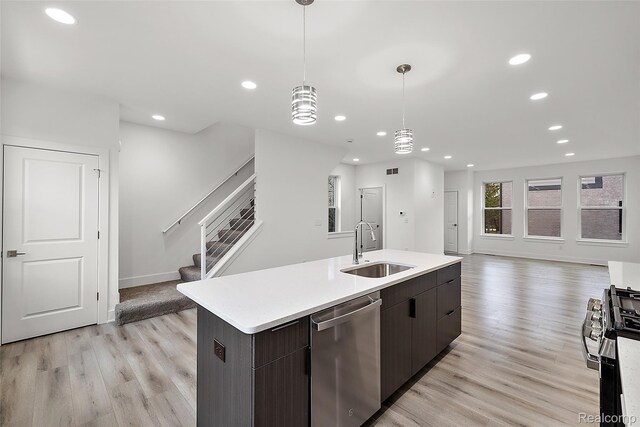 2817 Summers Pl, Troy, MI 48084 - kitchen featuring appliances with stainless steel finishes, a sink, recessed lighting, light wood-style flooring, and light countertops