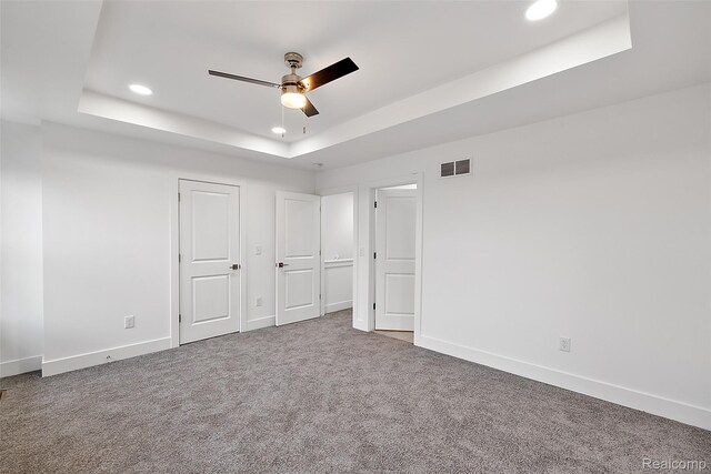 2817 Summers Pl, Troy, MI 48084 - unfurnished bedroom with a tray ceiling, recessed lighting, baseboards, carpet, and a ceiling fan