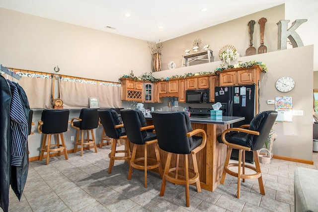 390 Iyopawa Rd, Coldwater, MI 49036 - indoor bar with black appliances, baseboards, and recessed lighting