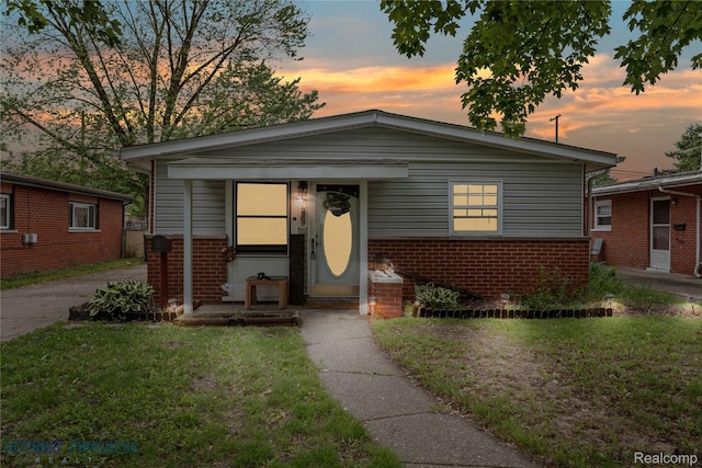 7953 Elm St, Taylor, MI 48180 - bungalow-style house featuring brick siding and a lawn