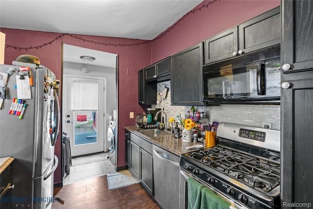 7953 Elm St, Taylor, MI 48180 - kitchen featuring appliances with stainless steel finishes, a sink, decorative backsplash, and wood-type flooring