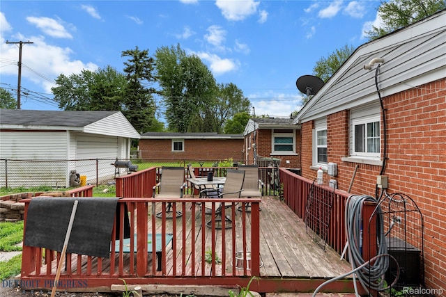 7953 Elm St, Taylor, MI 48180 - deck with outdoor dining area and a garage