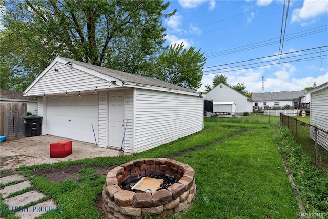 7953 Elm St, Taylor, MI 48180 - view of yard with an outdoor fire pit, an outbuilding, and a garage