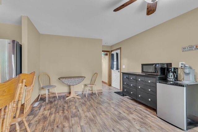 11245 Antcliff Rd, Brooklyn, MI 49230 - living area featuring a ceiling fan, wood finished floors, and baseboards
