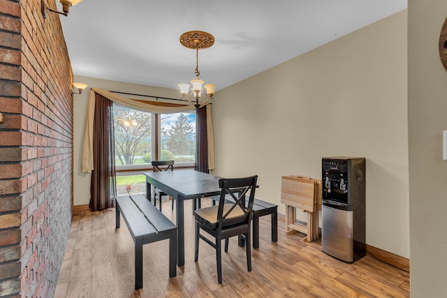 11245 Antcliff Rd, Brooklyn, MI 49230 - dining room with a chandelier, light wood-style flooring, and baseboards