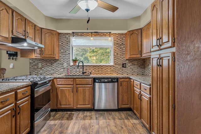11245 Antcliff Rd, Brooklyn, MI 49230 - kitchen with appliances with stainless steel finishes, a sink, brown cabinetry, and ceiling fan