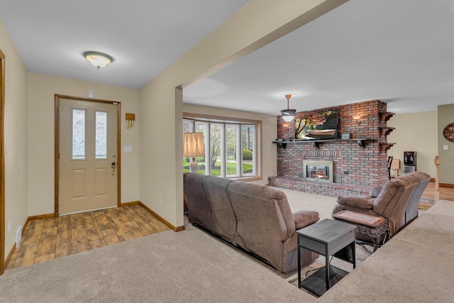 11245 Antcliff Rd, Brooklyn, MI 49230 - carpeted living area featuring a brick fireplace, baseboards, and wood finished floors