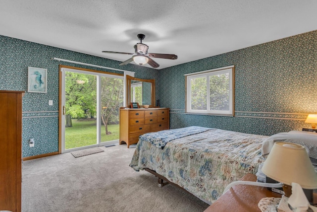 11245 Antcliff Rd, Brooklyn, MI 49230 - bedroom with wallpapered walls, access to outside, multiple windows, carpet, and ceiling fan