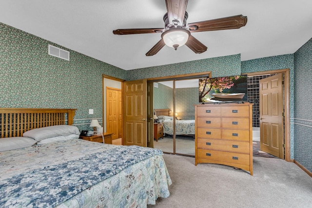 11245 Antcliff Rd, Brooklyn, MI 49230 - carpeted bedroom with wallpapered walls, a closet, and a ceiling fan