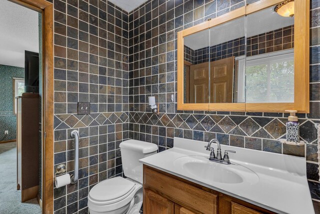 11245 Antcliff Rd, Brooklyn, MI 49230 - bathroom featuring tile walls, vanity, and toilet