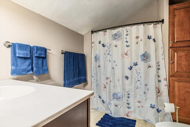 2875 Linco Rd, Berrien Springs, MI 49103 - bathroom with vaulted ceiling, vanity, a textured ceiling, a shower with shower curtain, and tile patterned floors