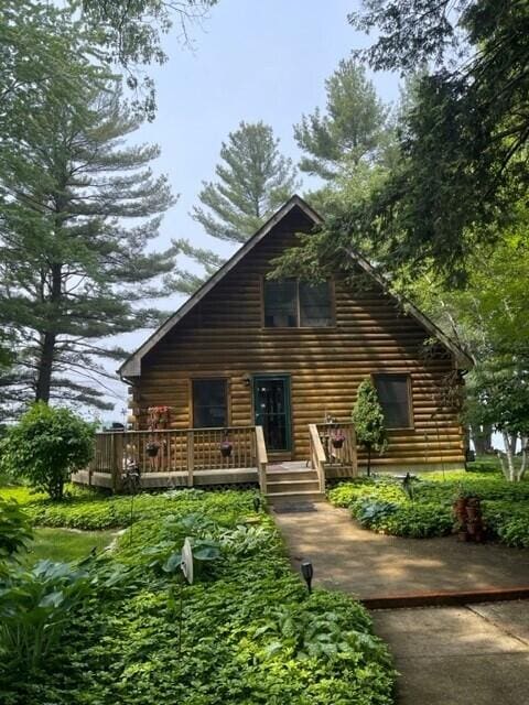71 Hubbard Woods Rd, Muskegon, MI 49442 - view of front facade with a wooden deck and log siding