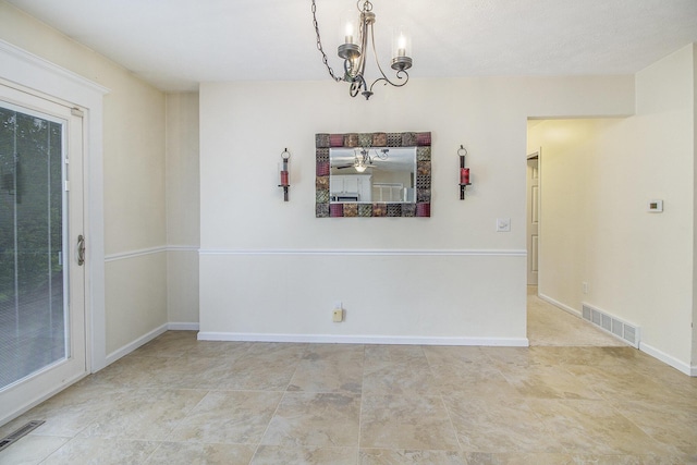 7289 Eagle Ter, Michigan, MI 49071 - unfurnished dining area with a chandelier and baseboards