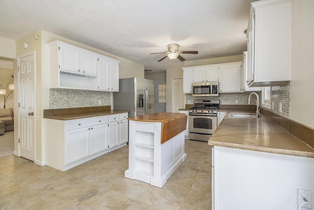7289 Eagle Ter, Michigan, MI 49071 - kitchen with open shelves, appliances with stainless steel finishes, a sink, and wood counters