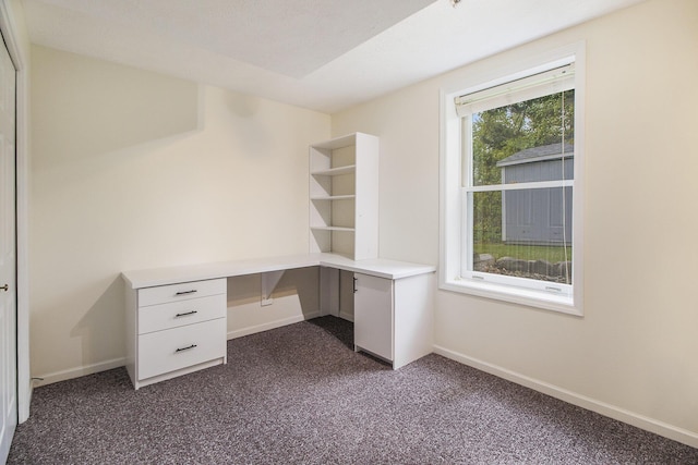 7289 Eagle Ter, Michigan, MI 49071 - unfurnished office featuring built in study area, dark carpet, and baseboards