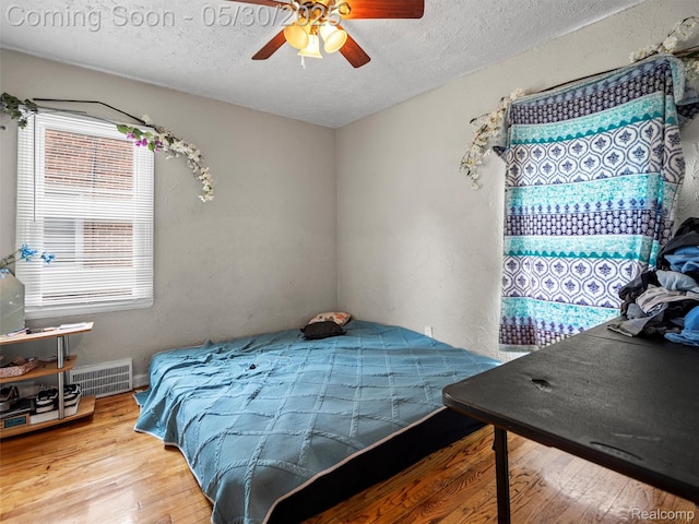 15058 Vaughan St, Detroit, MI 48223 - bedroom with multiple windows, a textured ceiling, wood finished floors, ceiling fan, and a textured wall