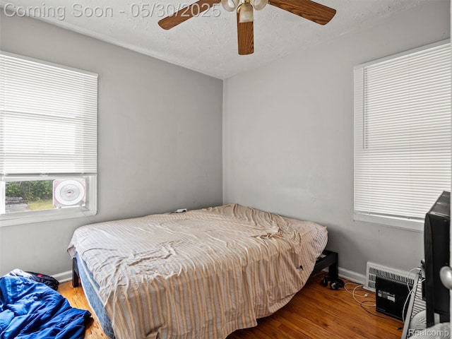 15058 Vaughan St, Detroit, MI 48223 - bedroom featuring wood finished floors, baseboards, a ceiling fan, and a textured ceiling