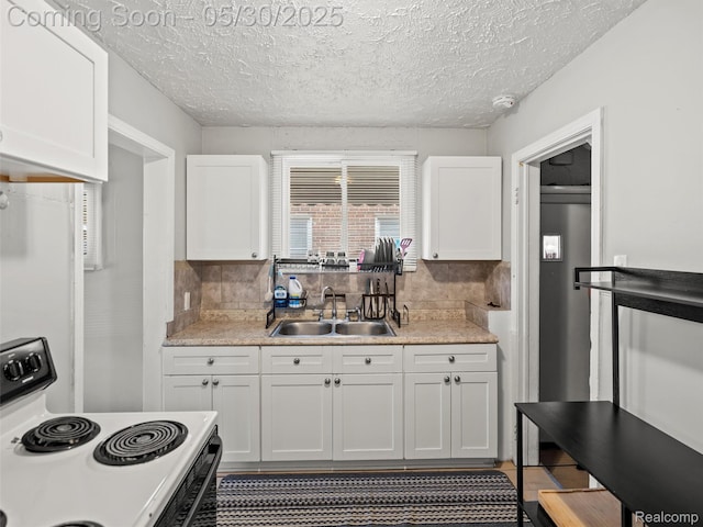 15058 Vaughan St, Detroit, MI 48223 - kitchen with white electric range, a sink, white cabinets, light countertops, and decorative backsplash