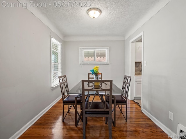 15058 Vaughan St, Detroit, MI 48223 - dining area featuring a textured ceiling, wood finished floors, and baseboards