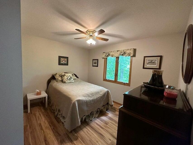 1720 Dimmers Rd, Reading, MI 49274 - bedroom with light wood finished floors, a textured ceiling, and a ceiling fan