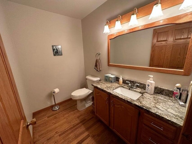 1720 Dimmers Rd, Reading, MI 49274 - half bathroom with wood finished floors, toilet, vanity, and baseboards