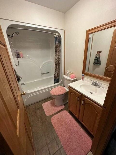 1720 Dimmers Rd, Reading, MI 49274 - bathroom with vanity, toilet, and shower / bath combination with curtain