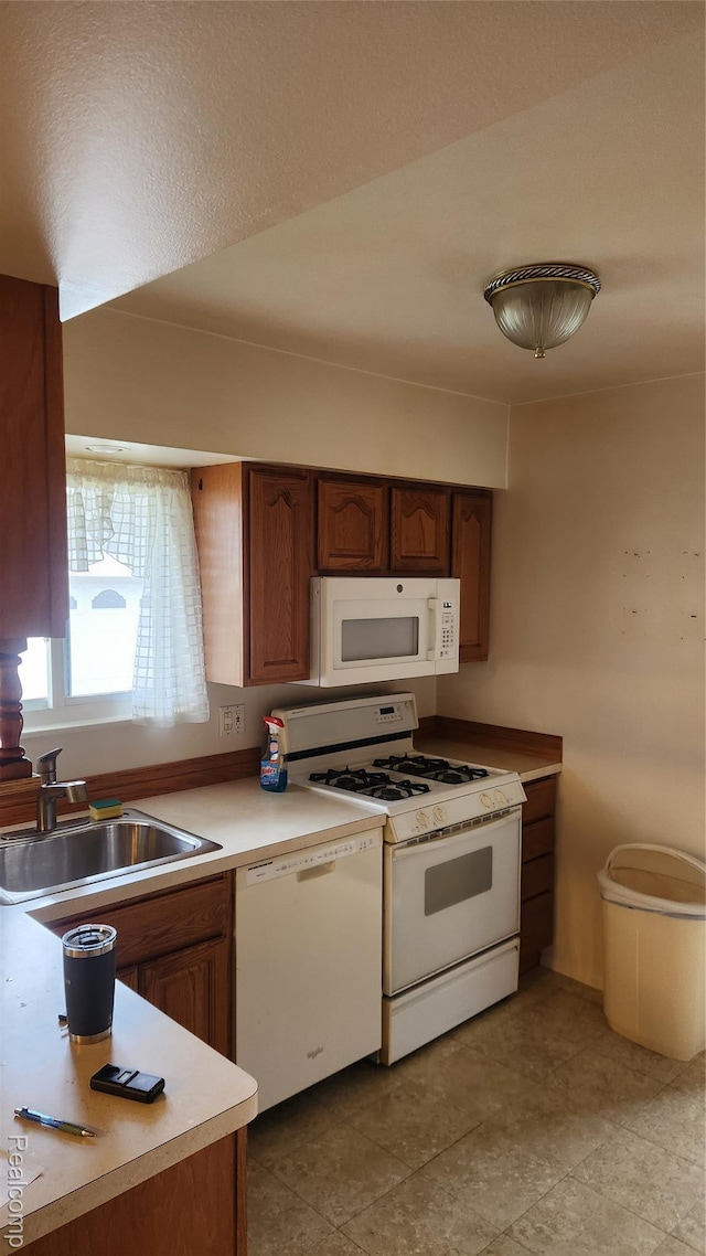 34245 Shawnee St, Westland, MI 48185 - kitchen featuring white appliances, a sink, light countertops, and brown cabinets