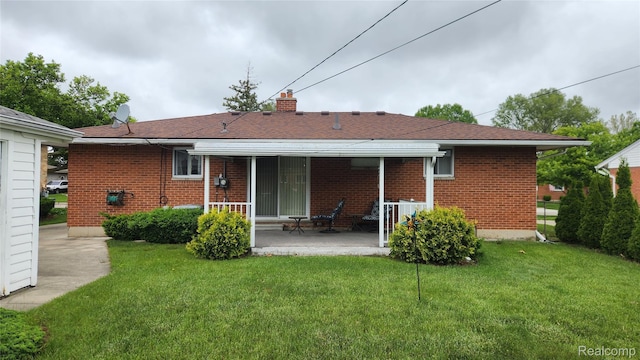 34245 Shawnee St, Westland, MI 48185 - rear view of house with a yard, brick siding, and a chimney