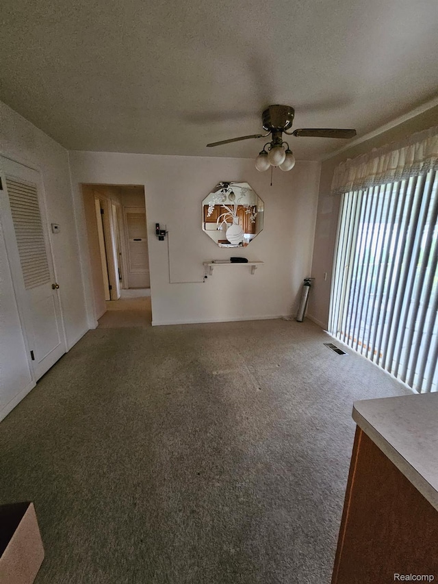 34245 Shawnee St, Westland, MI 48185 - unfurnished living room featuring ceiling fan, carpet floors, and a textured ceiling
