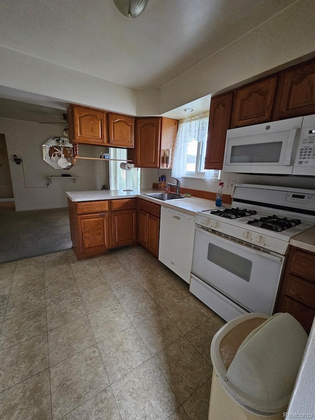 34245 Shawnee St, Westland, MI 48185 - kitchen with white appliances, a sink, light countertops, and brown cabinetry