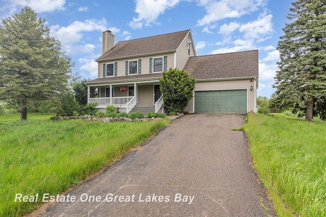 2203 Bullock Rd, Lapeer, MI 48446 - colonial home featuring a porch, a chimney, driveway, a garage, and a shingled roof