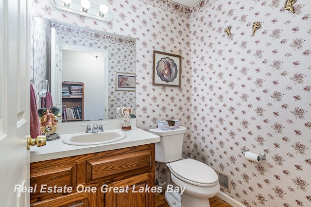 2203 Bullock Rd, Lapeer, MI 48446 - bathroom featuring wallpapered walls, toilet, and vanity