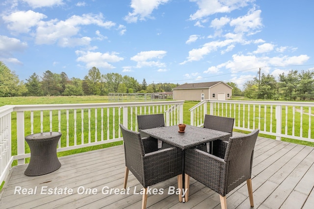 2203 Bullock Rd, Lapeer, MI 48446 - deck with outdoor dining area, a lawn, and an outdoor structure