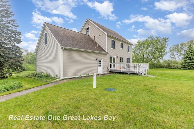 2203 Bullock Rd, Lapeer, MI 48446 - back of property with a wooden deck, a shingled roof, and a yard