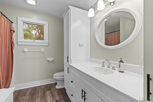 2803 Spielman Rd, Adrian, MI 49221 - full bathroom featuring vanity, toilet, wood finished floors, baseboards, and lofted ceiling