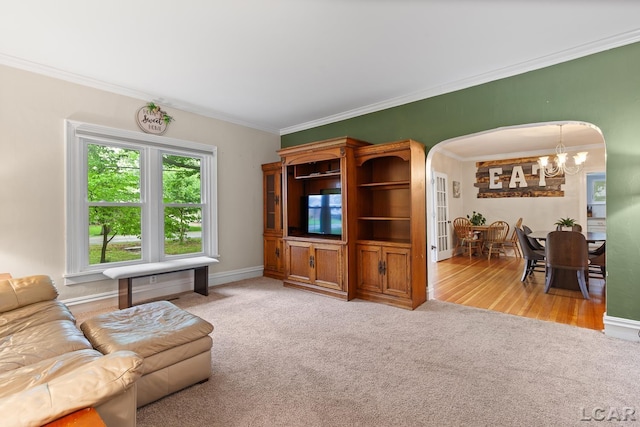 2803 Spielman Rd, Adrian, MI 49221 - carpeted living room with arched walkways, a chandelier, ornamental molding, and baseboards