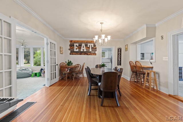 2803 Spielman Rd, Adrian, MI 49221 - dining room with french doors, a chandelier, wood finished floors, ornamental molding, and baseboards