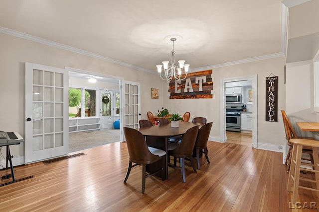 2803 Spielman Rd, Adrian, MI 49221 - dining area with french doors, a chandelier, light wood finished floors, ornamental molding, and baseboards