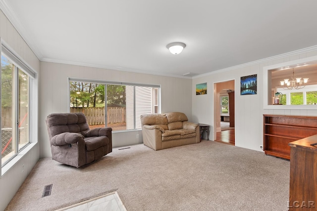 2803 Spielman Rd, Adrian, MI 49221 - carpeted living area featuring ornamental molding, plenty of natural light, and a chandelier