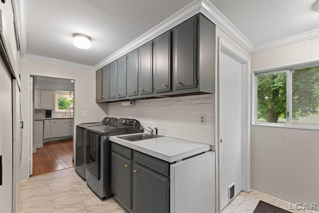 2803 Spielman Rd, Adrian, MI 49221 - laundry area with crown molding, cabinet space, light marble finish flooring, and washer and clothes dryer