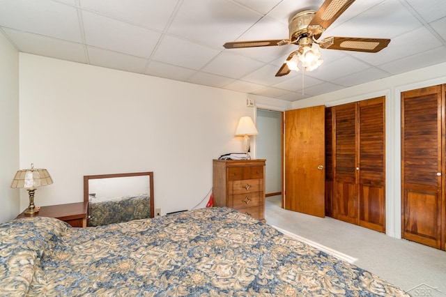 5295 E 14th St, Au Gres, MI 48703 - carpeted bedroom featuring two closets, a paneled ceiling, and a ceiling fan