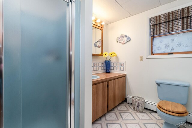 5295 E 14th St, Au Gres, MI 48703 - bathroom with vanity, toilet, a shower with shower door, and a baseboard heating unit