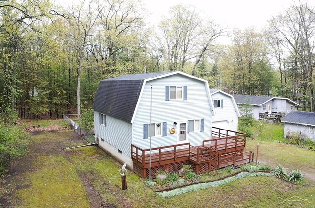5295 E 14th St, Au Gres, MI 48703 - back of house featuring roof with shingles, a wooden deck, crawl space, a gambrel roof, and a garage