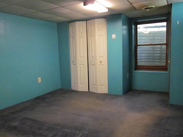 9303 County Road 653, Gobles, MI 49055 - unfurnished bedroom with a drop ceiling, carpet floors, and a closet